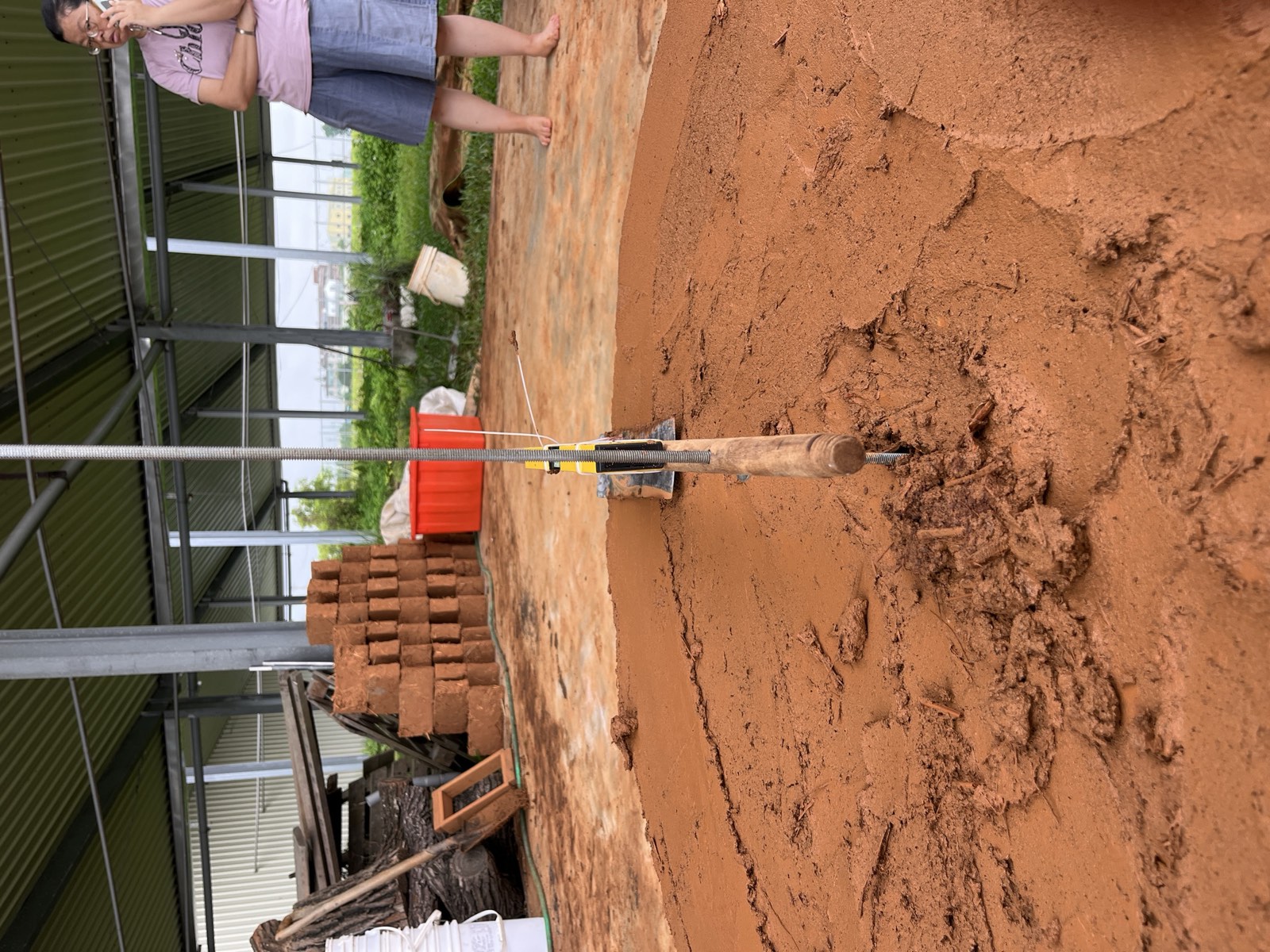 Roter Lehmpatch-Probe auf grauem Beton, quadratisch, Taiwan-Putztest